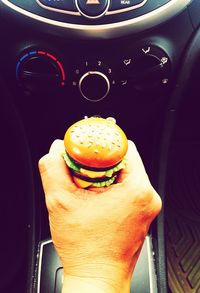 Close-up of hand holding ice cream in car