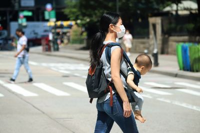 Rear view of women walking on road