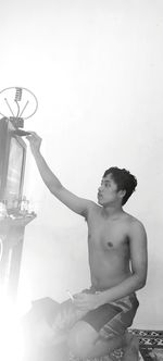 Man looking at swimming pool against sky