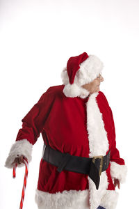 Midsection of man with umbrella on snow against white background