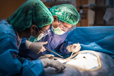 Surgeons performing surgery in operating room