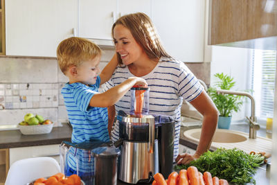 Portrait of smiling girl holding food at home