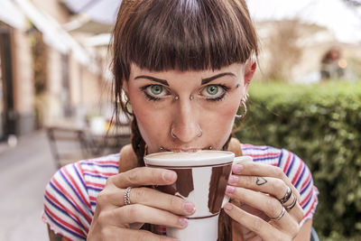 Portrait of woman drinking coffee