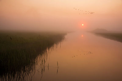 Scenic view of lake during sunset