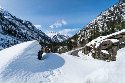 Scenic view of snow mountains against blue sky