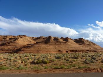 Scenic view of rocky mountains against cloudy sky