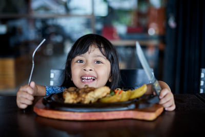 Portrait of boy with ice cream in plate