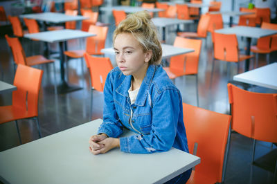 Woman sitting on chair in supermarket