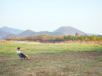 Full length of man on landscape against clear sky