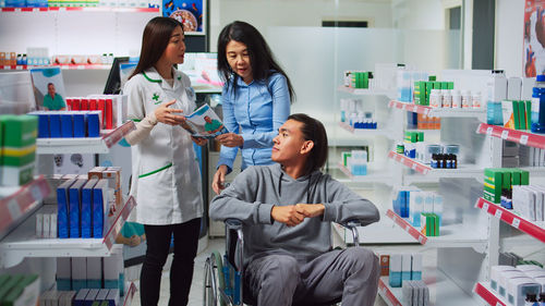 Portrait of smiling female friends standing in store