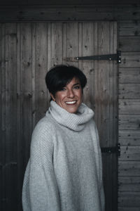 Portrait of smiling man standing in snow