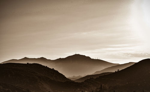 Scenic view of silhouette mountains against sky during sunset