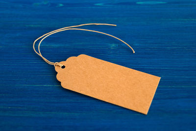 High angle view of paper on table against blue background