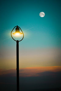 Low angle view of illuminated street light against sky at night