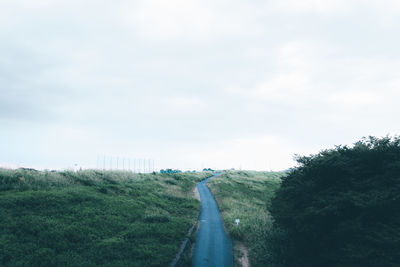 Narrow road along countryside landscape