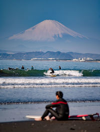 People on beach against sky