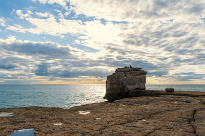 Scenic view of rock against sea