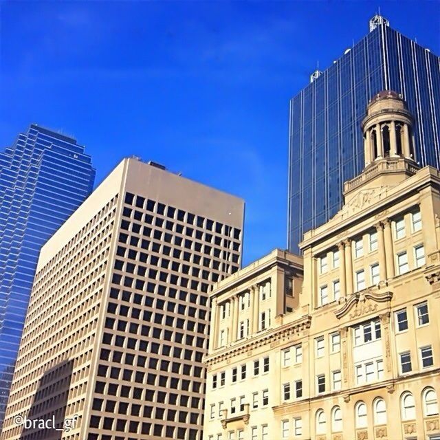 building exterior, architecture, built structure, blue, low angle view, city, clear sky, modern, tall - high, skyscraper, office building, building, tower, sky, sunlight, window, day, outdoors, no people, city life