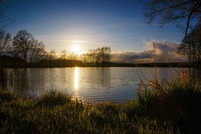 Scenic view of lake against sky during sunset