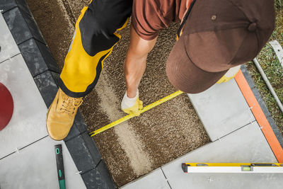 Low section of man standing on footpath