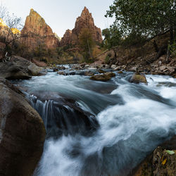 Scenic view of river flowing through rocks