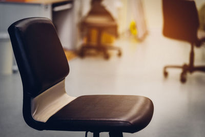 Close-up of empty chair on table