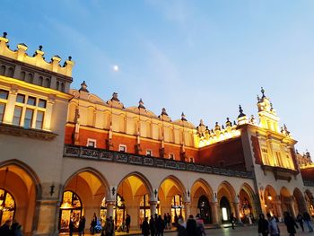 Low angle view of people in town square