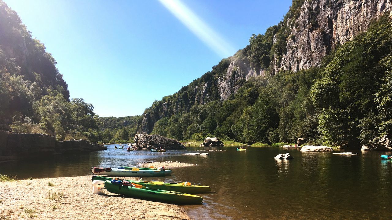 BOATS MOORED IN RIVER