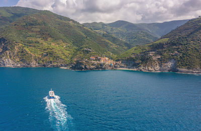 High angle view of sea by mountains