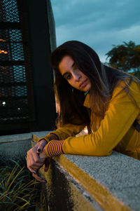 Portrait of smiling young woman sitting outdoors