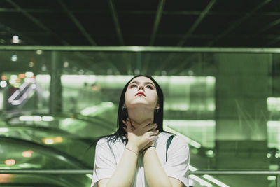 Young woman looking up indoors