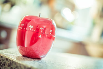 Close-up of apple shape dial on table