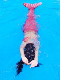 Full length of woman swimming in pool