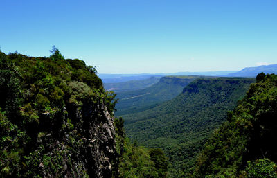 Scenic view of mountains against blue sky