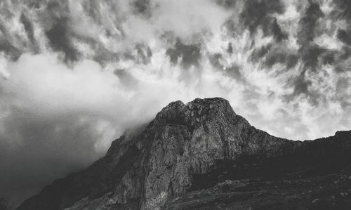 Low angle view of rock formation against sky