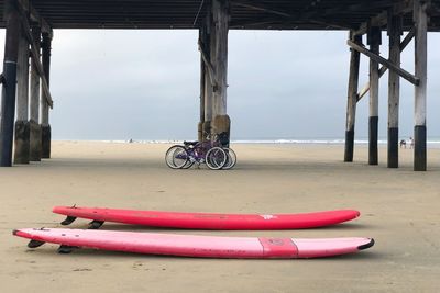 Bicycle on beach against sky