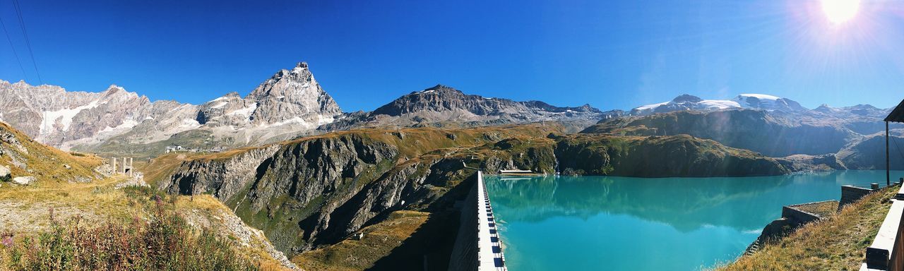 water, blue, beauty in nature, nature, scenics, no people, tree, sky, mountain, day, low angle view, outdoors