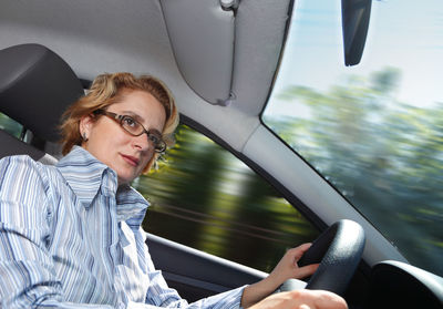 Mature woman driving car