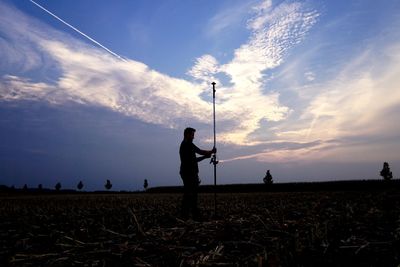 Man working on field against sky