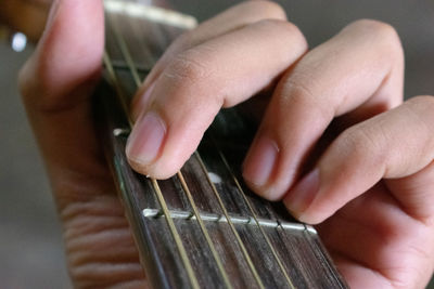 Midsection of person playing guitar