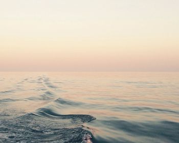 Scenic view of sea against clear sky during sunset