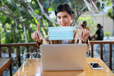 Portrait of woman sitting on table