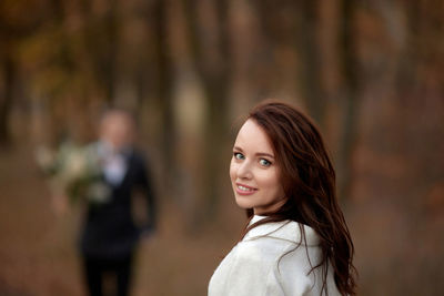 Portrait of young woman standing outdoors