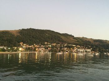 Scenic view of river and mountains against clear sky