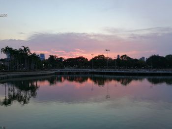 Scenic view of lake against sky at sunset