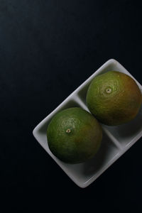 High angle view of fruits in plate on table