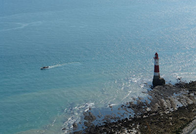 High angle view of lighthouse by sea against sky