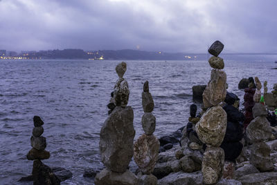 Rocks on beach against sky