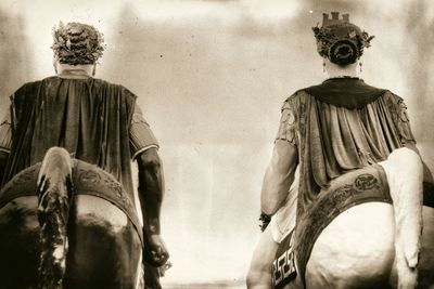 Rear view of man and statue