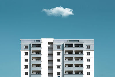 Low angle view of modern building against blue sky